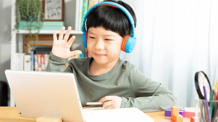 Kid learning English online with headphones